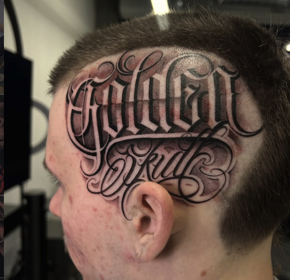Golden Skull script head tattoo